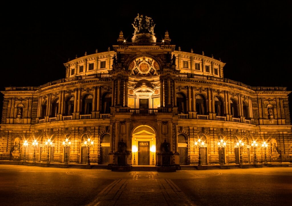 The iconic Semperoper in Dresden, Germany beautifully illuminated against the night sky.