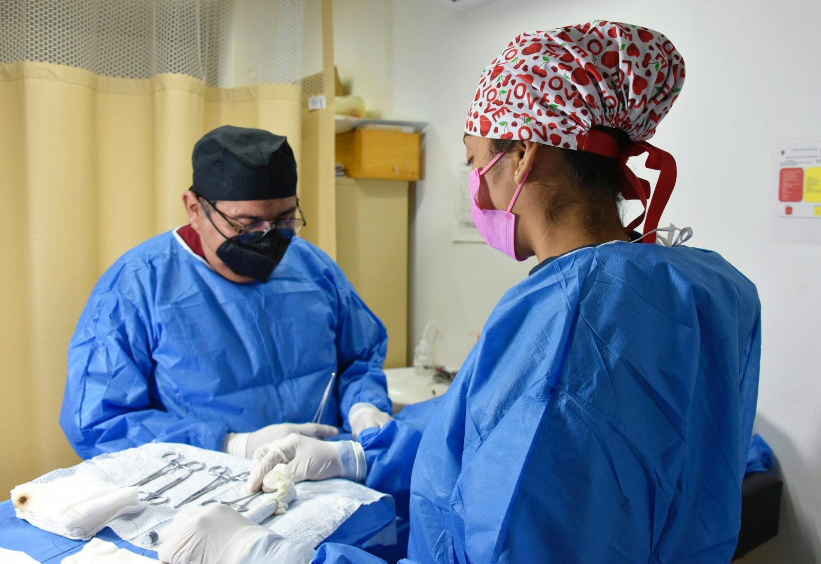 Medical team performing surgery with masks and gowns for safety and hygiene.